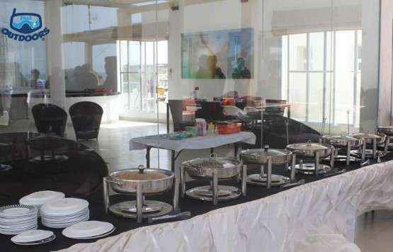 Corporate lunch setup at Turtle Beach with luxury huts, water sports, and breathtaking ocean views.